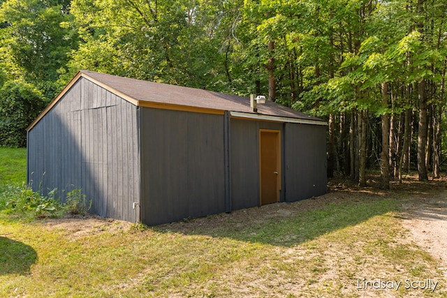 view of outbuilding featuring a lawn