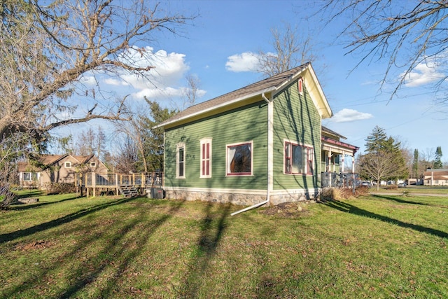 view of side of home featuring a lawn, cooling unit, and a deck