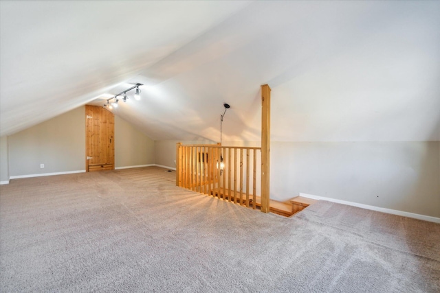 bonus room featuring carpet flooring and vaulted ceiling