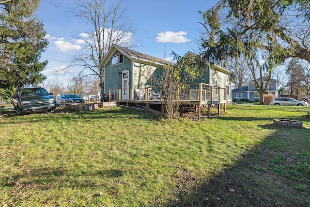 view of yard featuring an outdoor fire pit and a wooden deck