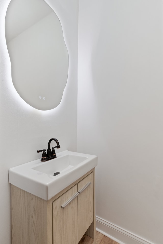 bathroom with hardwood / wood-style floors and vanity