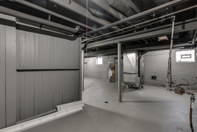 basement with brick wall, heating unit, and water heater