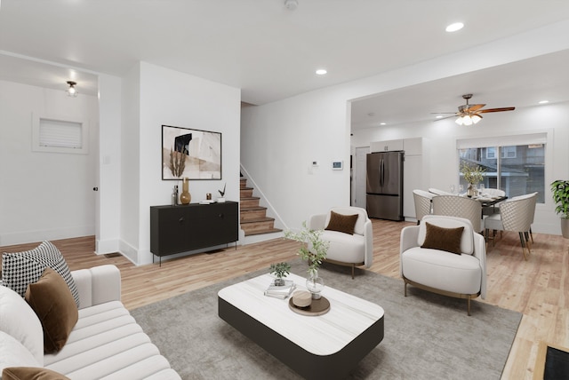 living room with ceiling fan and light hardwood / wood-style floors