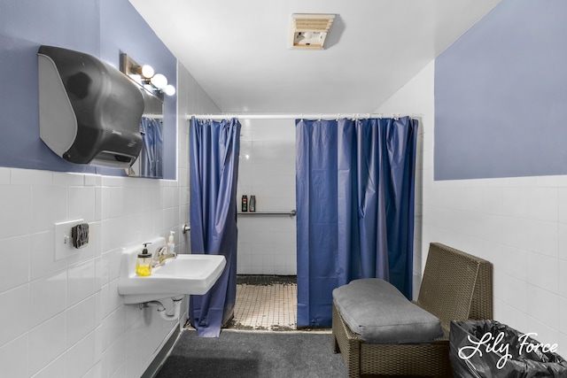 bathroom featuring a shower with shower curtain, sink, tile walls, and tile patterned floors