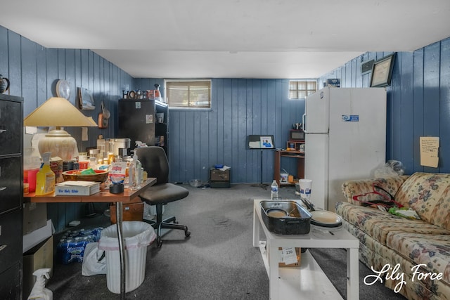 carpeted office space featuring wood walls and plenty of natural light