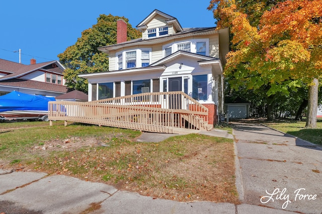 view of front of home with a sunroom and a deck