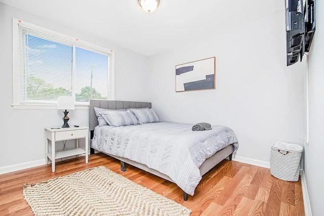 bedroom with wood-type flooring