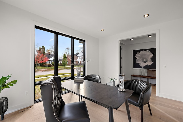 dining space with light hardwood / wood-style floors