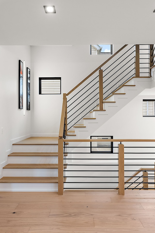 stairs featuring hardwood / wood-style flooring