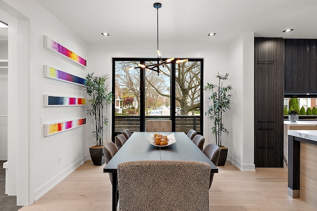 dining space featuring a chandelier and light wood-type flooring