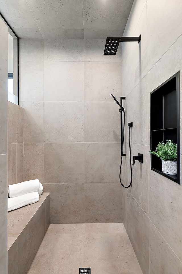 bathroom with a tile shower