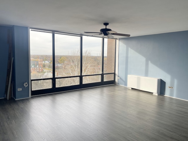 unfurnished room with ceiling fan, a healthy amount of sunlight, and hardwood / wood-style flooring