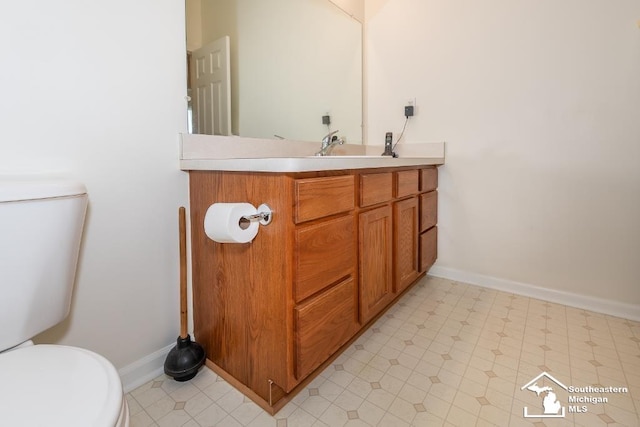 bathroom featuring toilet and vanity