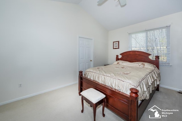 bedroom with lofted ceiling, ceiling fan, and light colored carpet