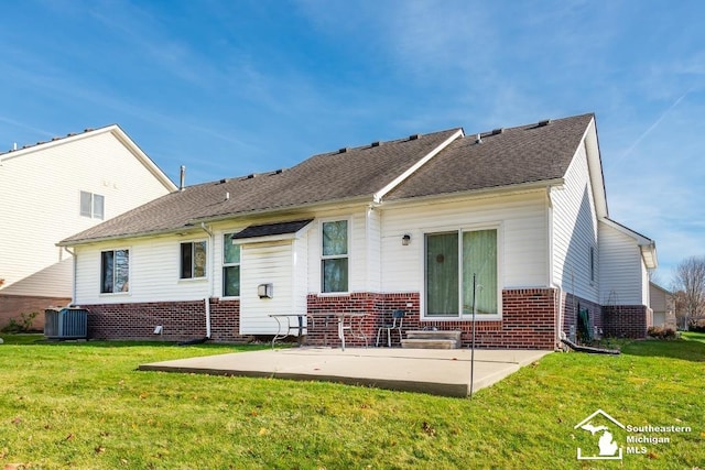 back of house with a patio, a yard, and central air condition unit