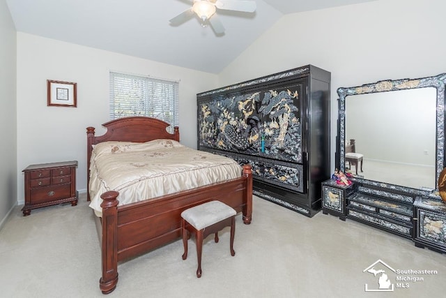 bedroom with ceiling fan, vaulted ceiling, and light carpet