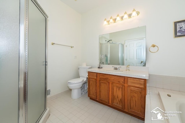 bathroom featuring tile patterned floors, an enclosed shower, vanity, and toilet