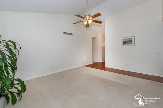 spare room featuring ceiling fan, high vaulted ceiling, and carpet flooring