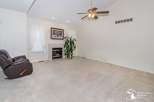 unfurnished living room featuring ceiling fan, light colored carpet, lofted ceiling, and a fireplace