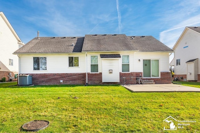 back of house featuring cooling unit, a patio, and a yard