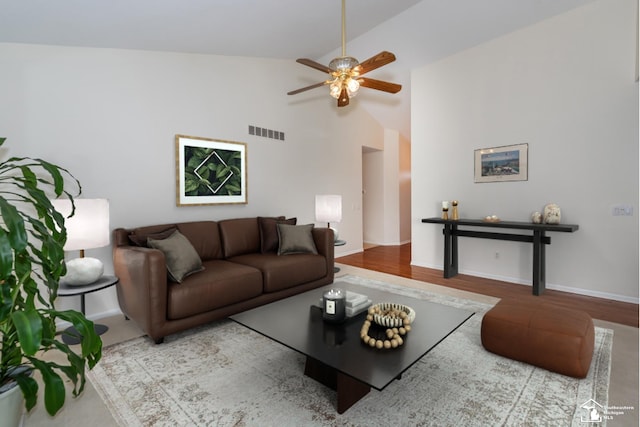 living room featuring high vaulted ceiling, ceiling fan, and light hardwood / wood-style flooring