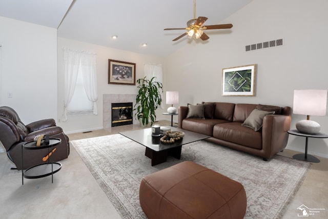 carpeted living room featuring a fireplace, high vaulted ceiling, and ceiling fan