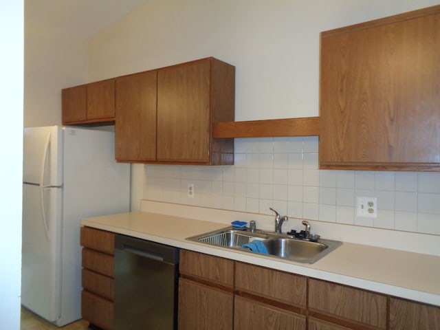 kitchen with decorative backsplash, dishwasher, white refrigerator, and sink