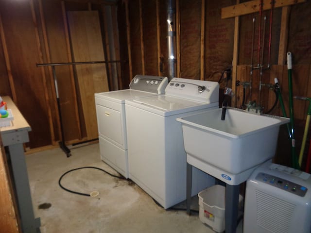 washroom with independent washer and dryer and sink