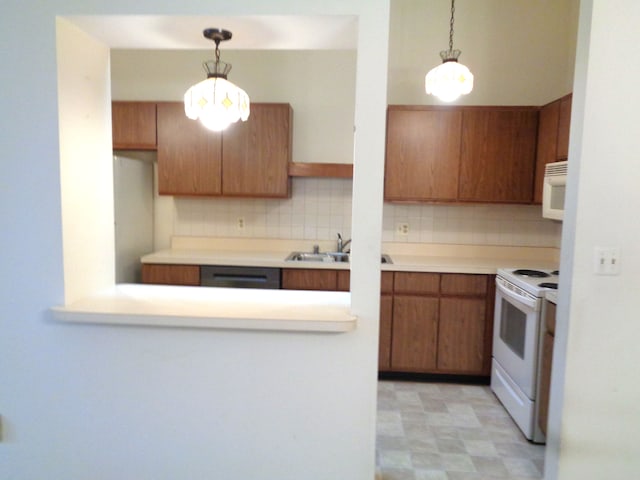 kitchen with white appliances, tasteful backsplash, hanging light fixtures, and sink