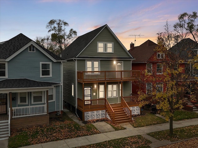 view of front facade featuring covered porch and a balcony