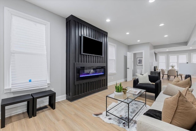 living room with a fireplace and light hardwood / wood-style flooring