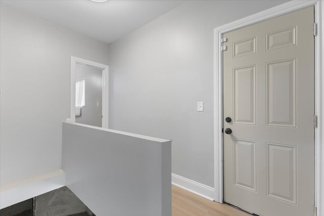 hallway with light hardwood / wood-style flooring