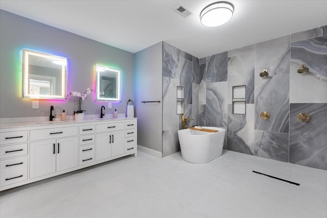 bathroom with vanity and independent shower and bath