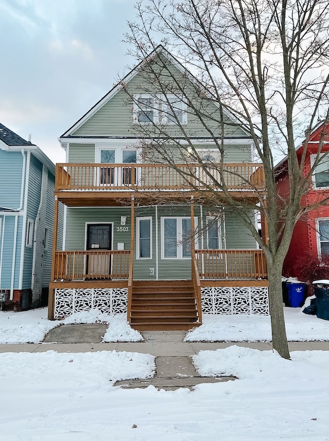 view of front facade featuring covered porch and a balcony