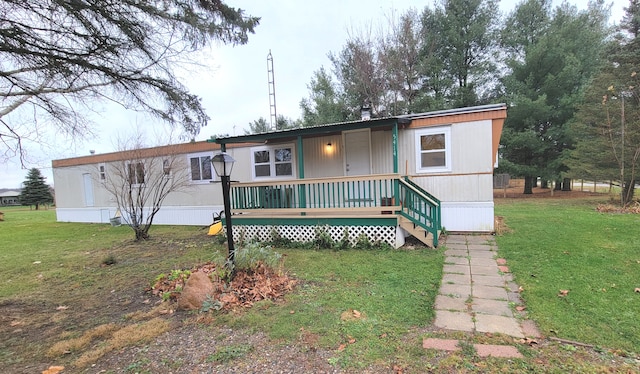 view of front of home with a porch and a front yard