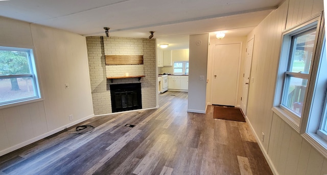 unfurnished living room with hardwood / wood-style flooring and a fireplace