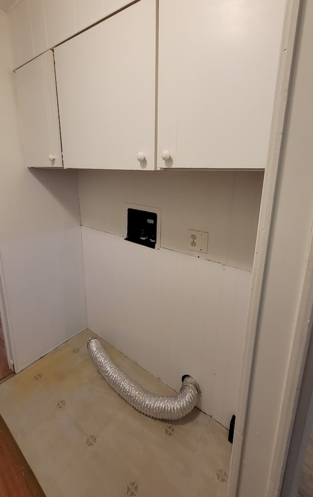 laundry area featuring hookup for an electric dryer and cabinets