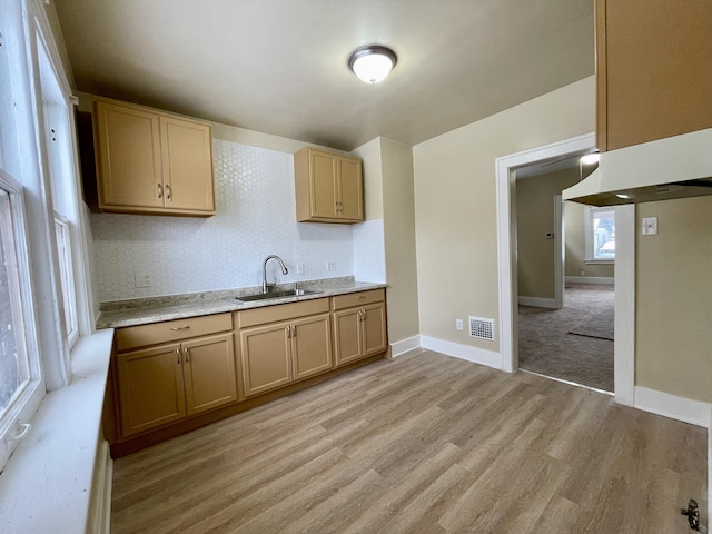 kitchen featuring light brown cabinets, sink, and light hardwood / wood-style flooring