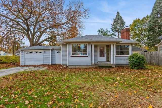 ranch-style house featuring a front lawn and a garage