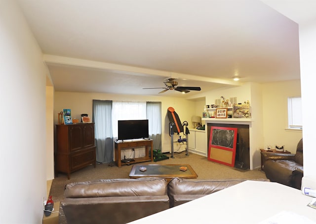 carpeted living room with ceiling fan