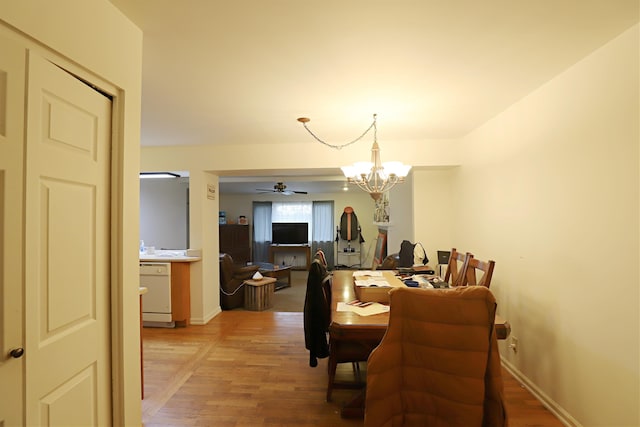 dining space featuring ceiling fan with notable chandelier and wood-type flooring