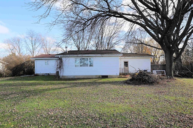 back of house with a lawn