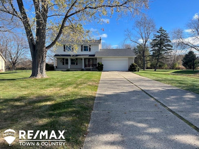 view of front of house with a front yard and a garage