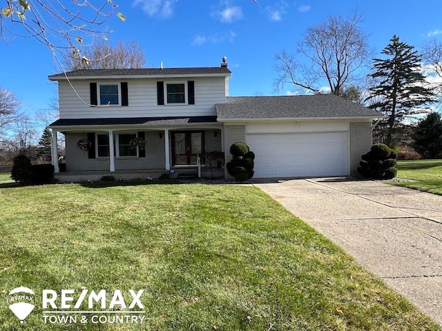 view of front property featuring covered porch, a garage, and a front lawn