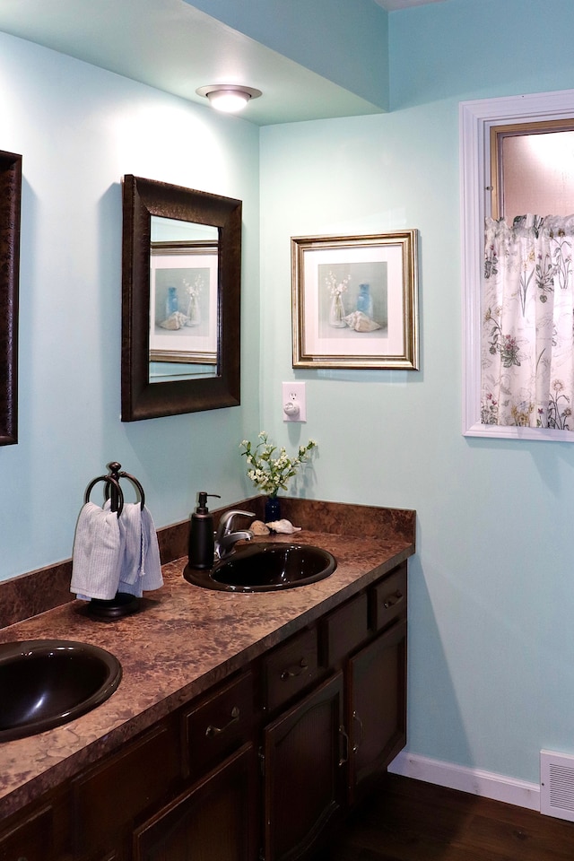 bathroom with vanity and hardwood / wood-style flooring