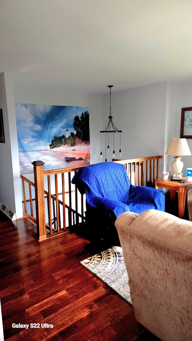 living room with hardwood / wood-style flooring and a textured ceiling