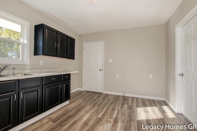 kitchen featuring light wood-type flooring and sink