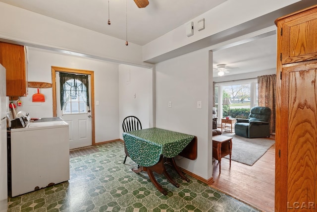 dining space with dark hardwood / wood-style floors, ceiling fan, and separate washer and dryer