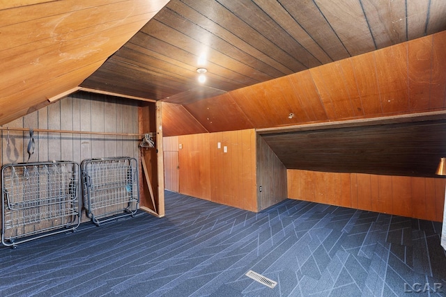 bonus room with wood walls, wood ceiling, lofted ceiling, and dark carpet