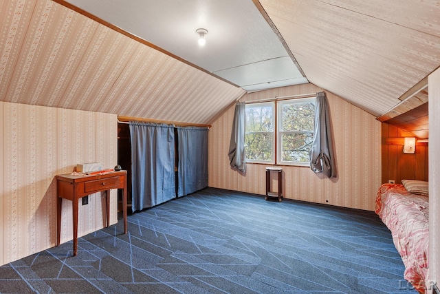 bonus room featuring dark carpet and lofted ceiling